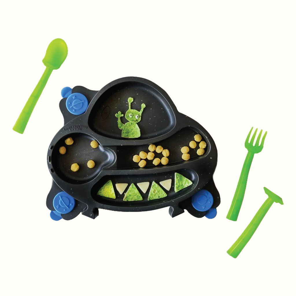 Image showing the UFO training plate with kix cereal, triangle shaped spinach tortilla and white cheese, and an alien made out of spinach tortilla. Also featured are three green training utensils; a pusher, fork, and spoon.