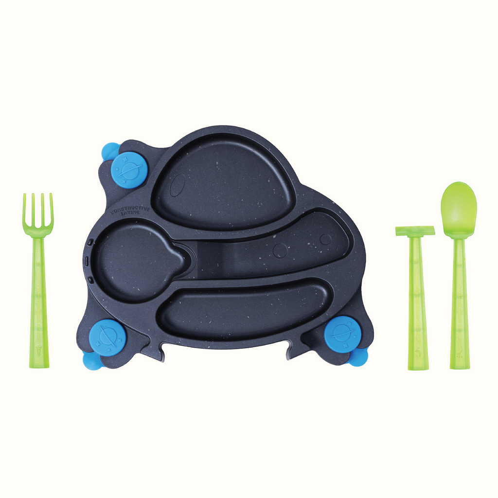 Image of the spacedust UFO Training Plate and Utensils. The green utensils include a pusher, fork and spoon, and are located next to the plate.are located next to the plate.