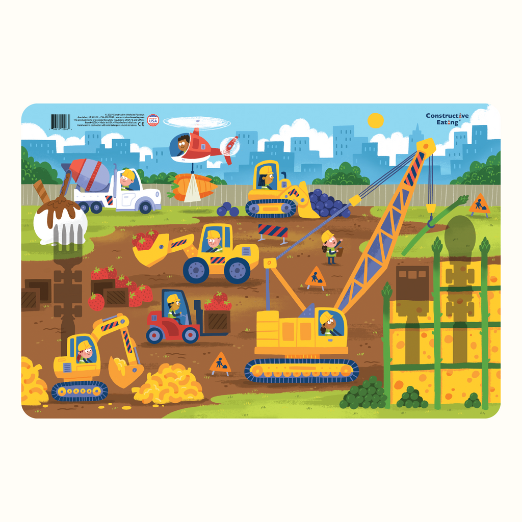 Image of the Construction Placemat. The Placemat illustrates a construction worksite with construction vehicles working with food such as mac & cheese, blueberries, and ice cream.