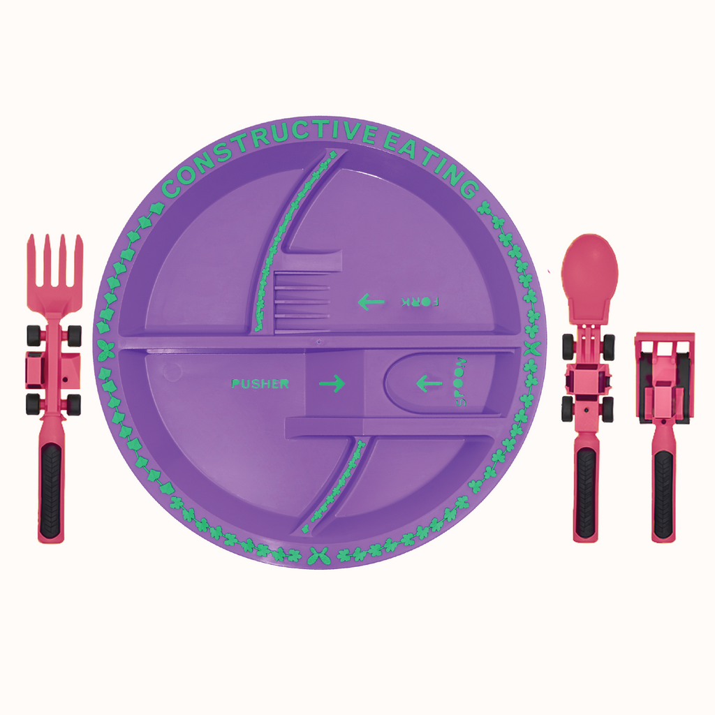 Image of the pink Construction Utensils and purple Plate. The pink utensils include a bull dozer pusher, a fork lift fork, and a front loader spoon. The plate is purple. The utensils are located next to the plate.