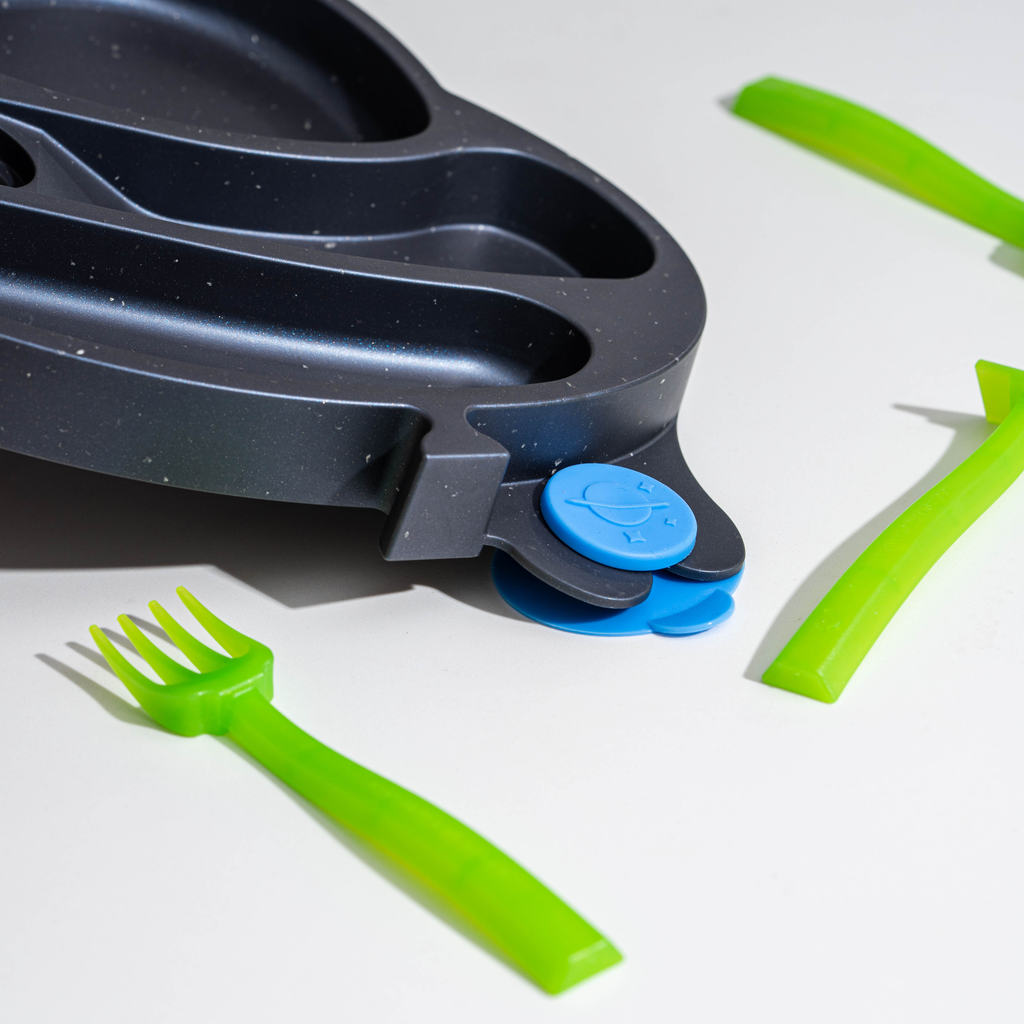 Image showing the suction strength of the training plates. One side of the plate is being lifted while the suction cups keep the other side of the plate stuck to the table.